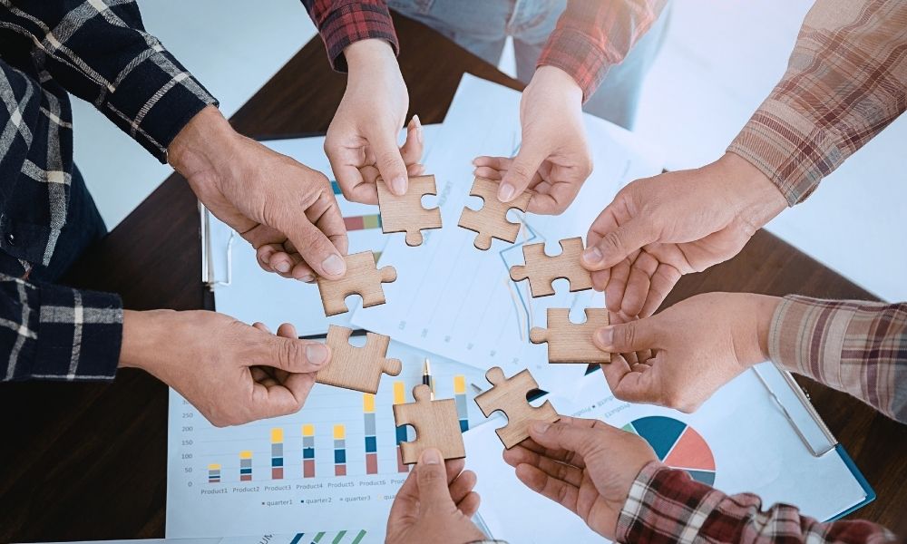 group of people working together to solve the puzzle