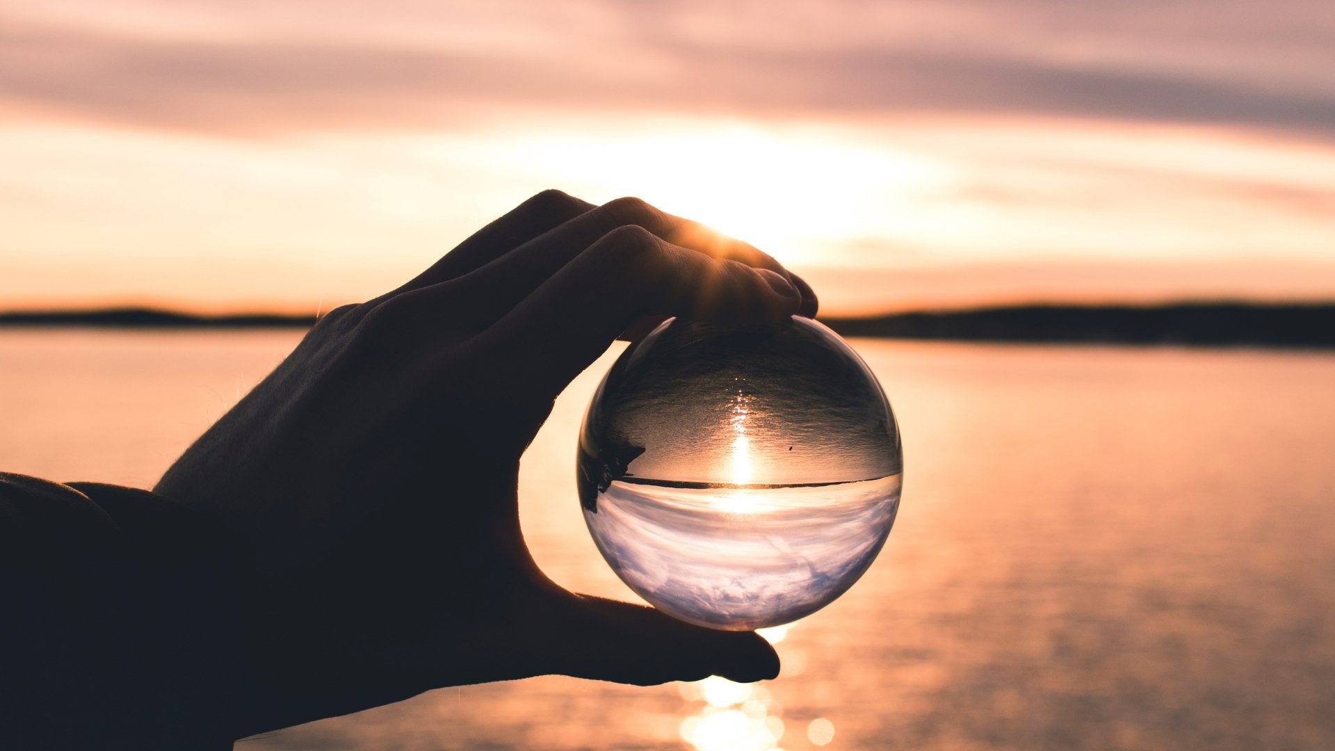 hand holding clear glass ball