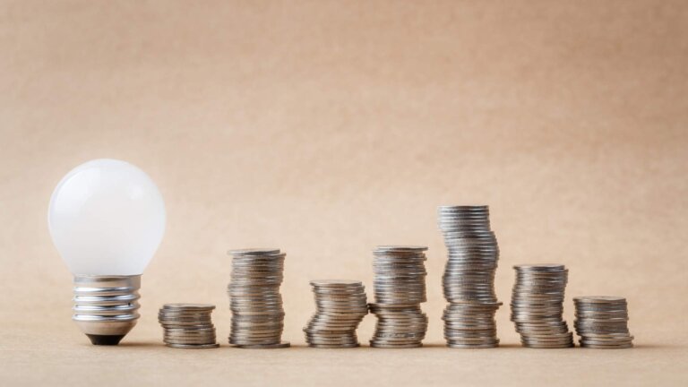 heap of coins with small light bulb