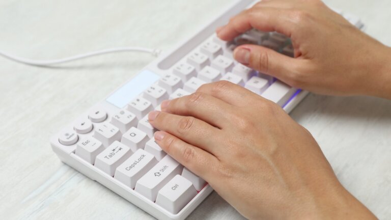 human typing in white keyboard
