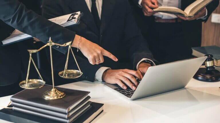 lawyers writing a file in laptop