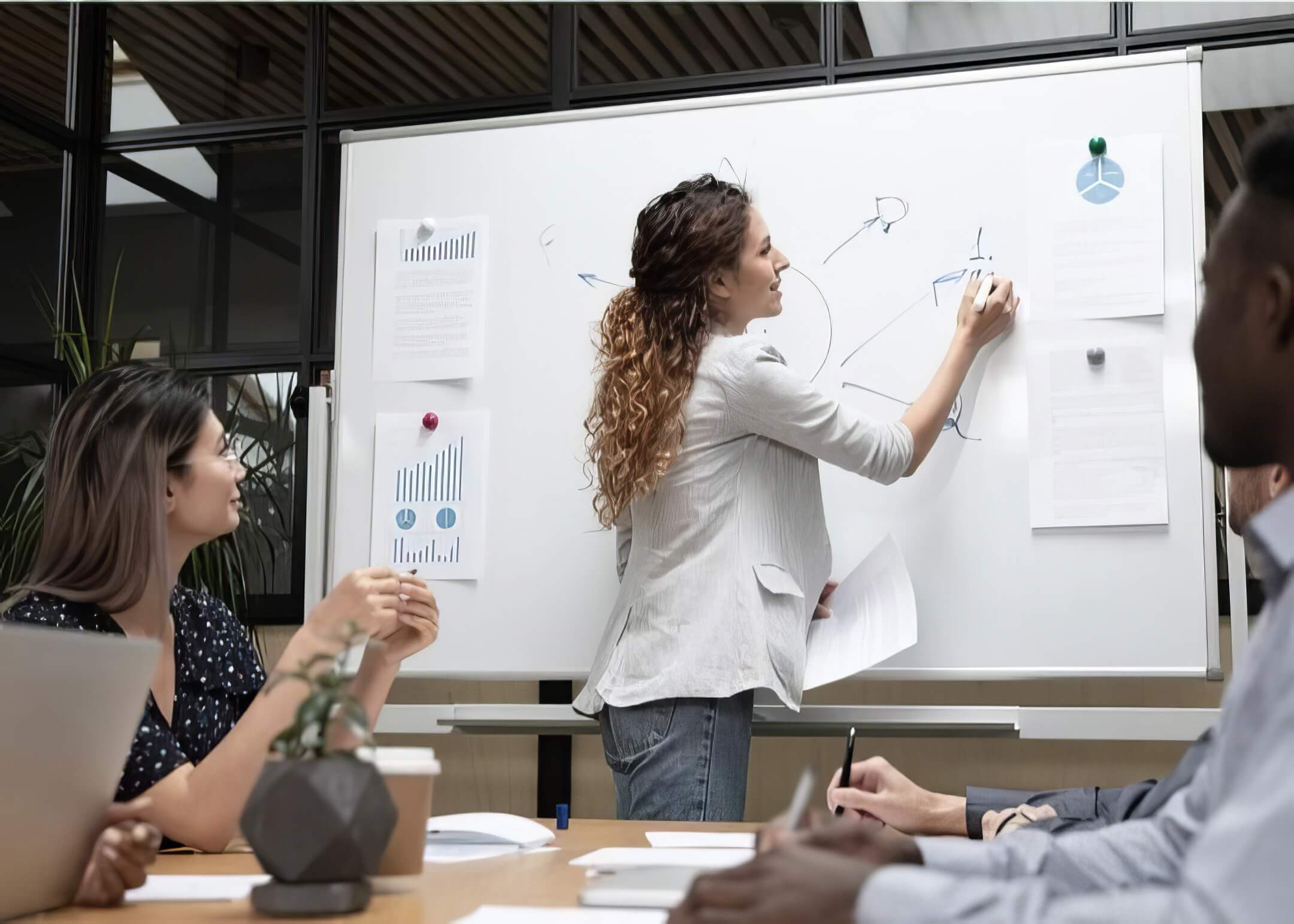 leader writing their website maintenance plan in a board