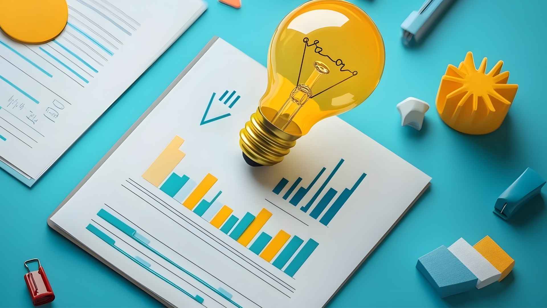 lightbulb on top of paper with graphs