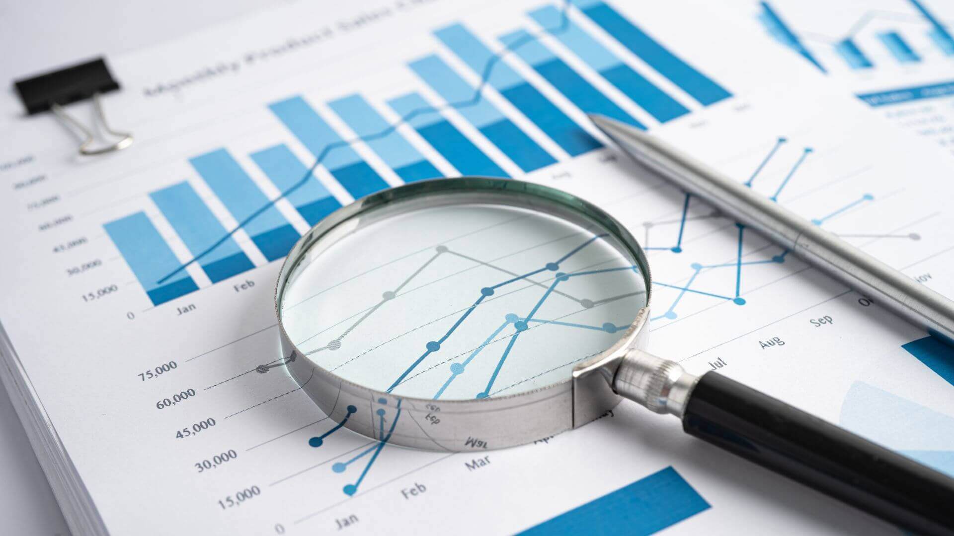 magnifying glass and a report analysis