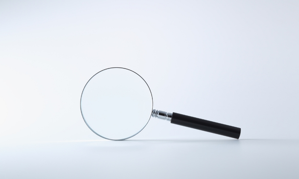 magnifying glass in white opaque background