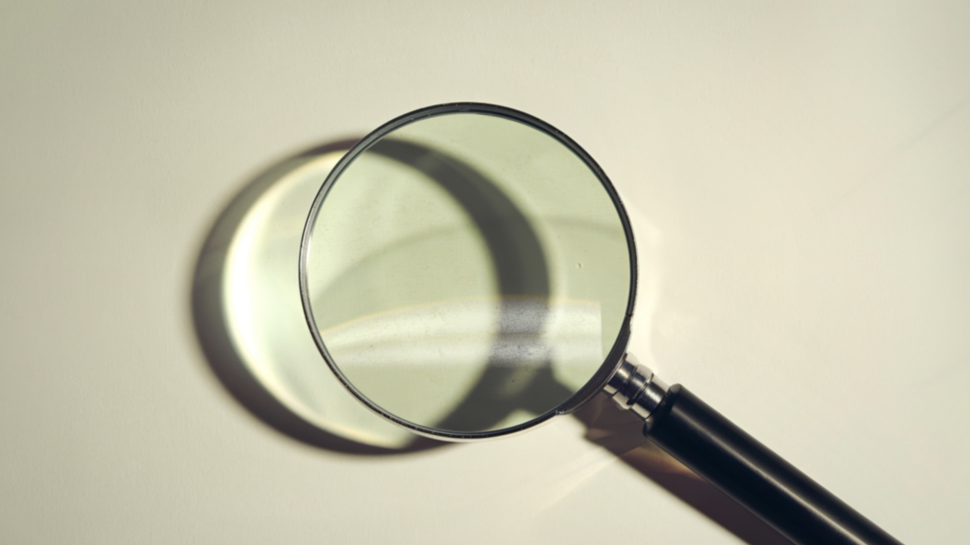 magnifying glass on beige background