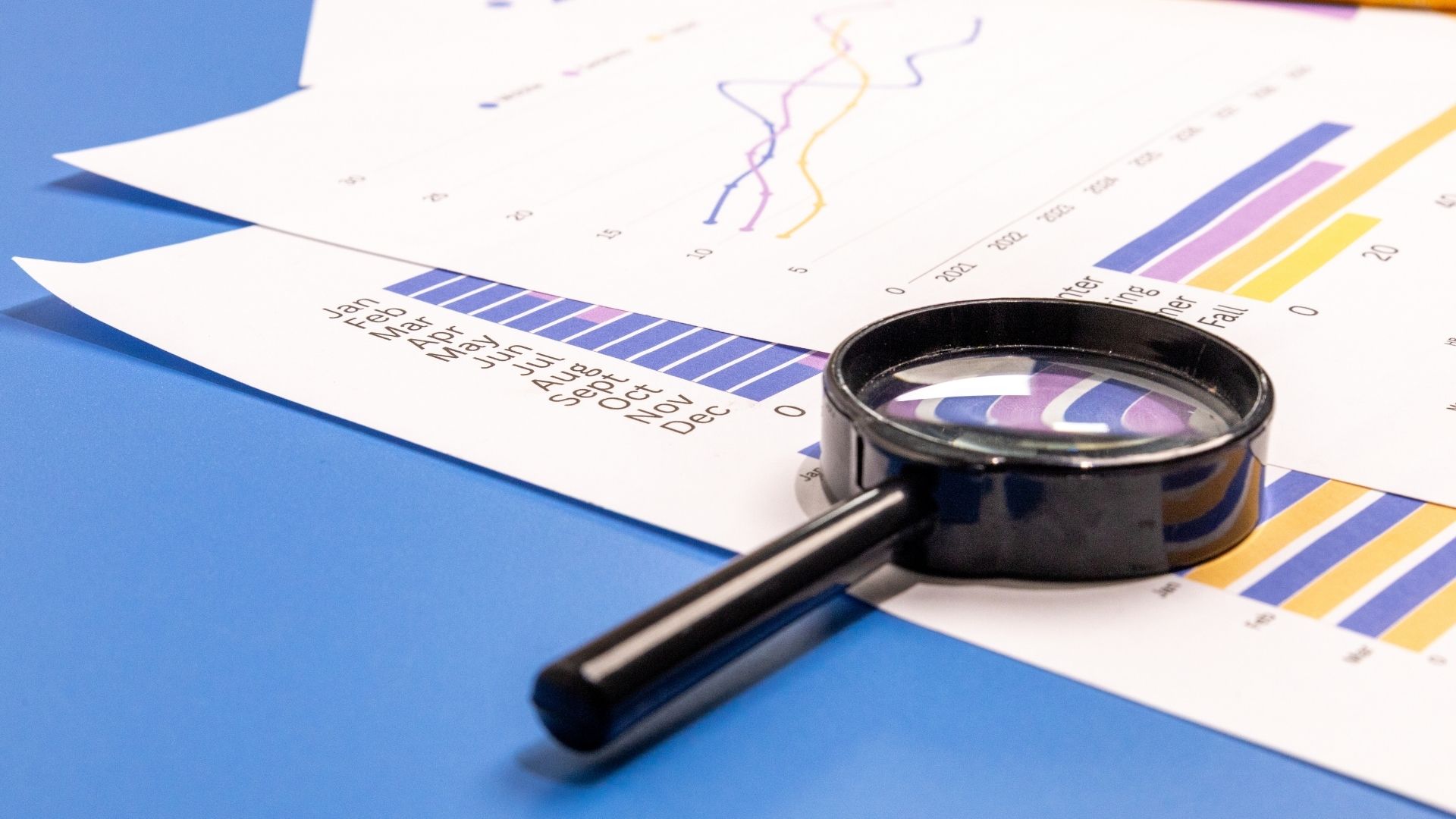 magnifying glass over charts