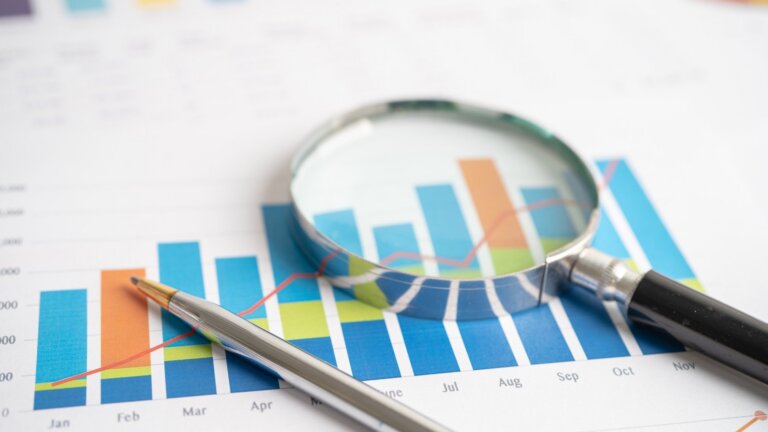 magnifying glass with charts
