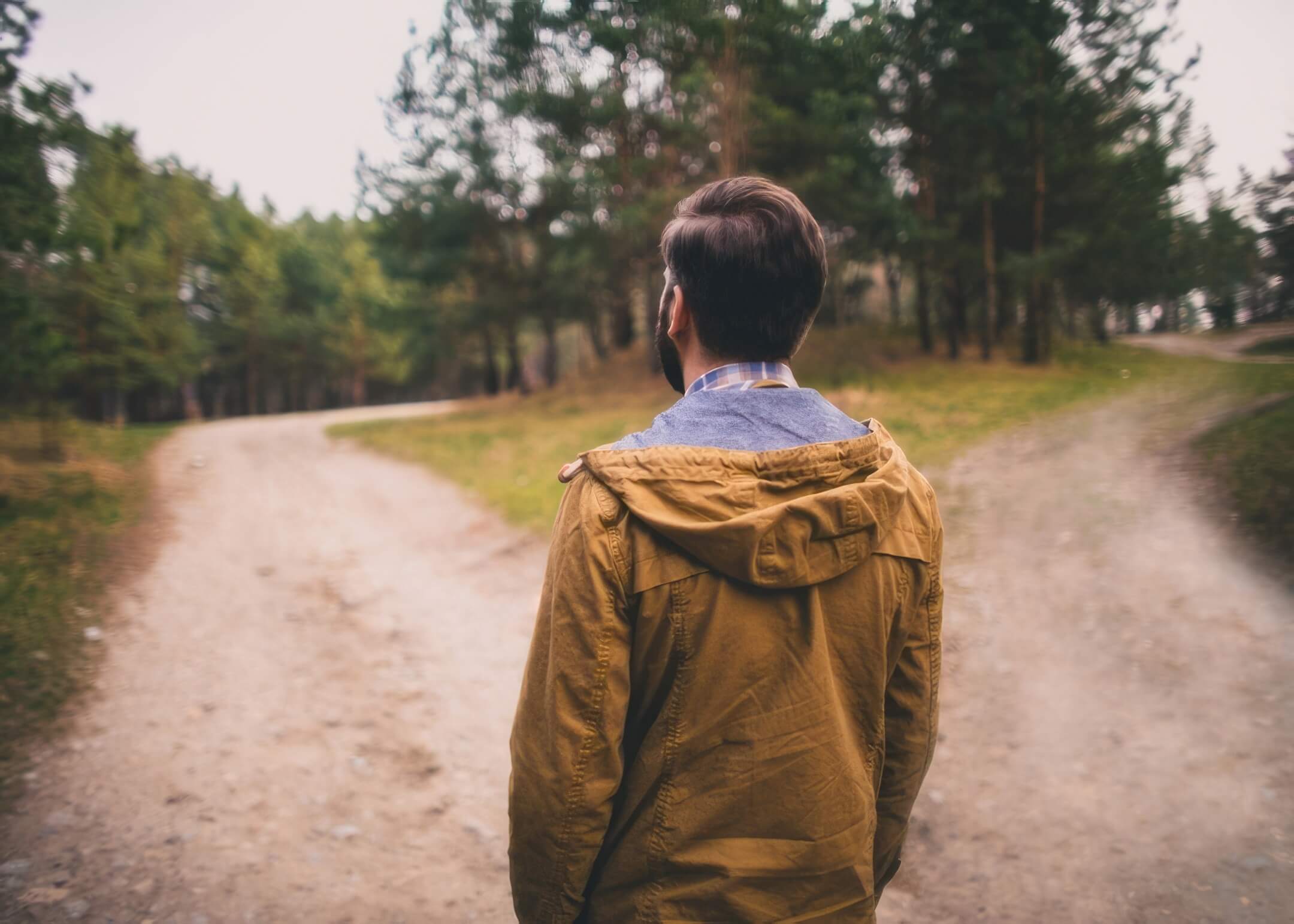 man choosing between two paths to take