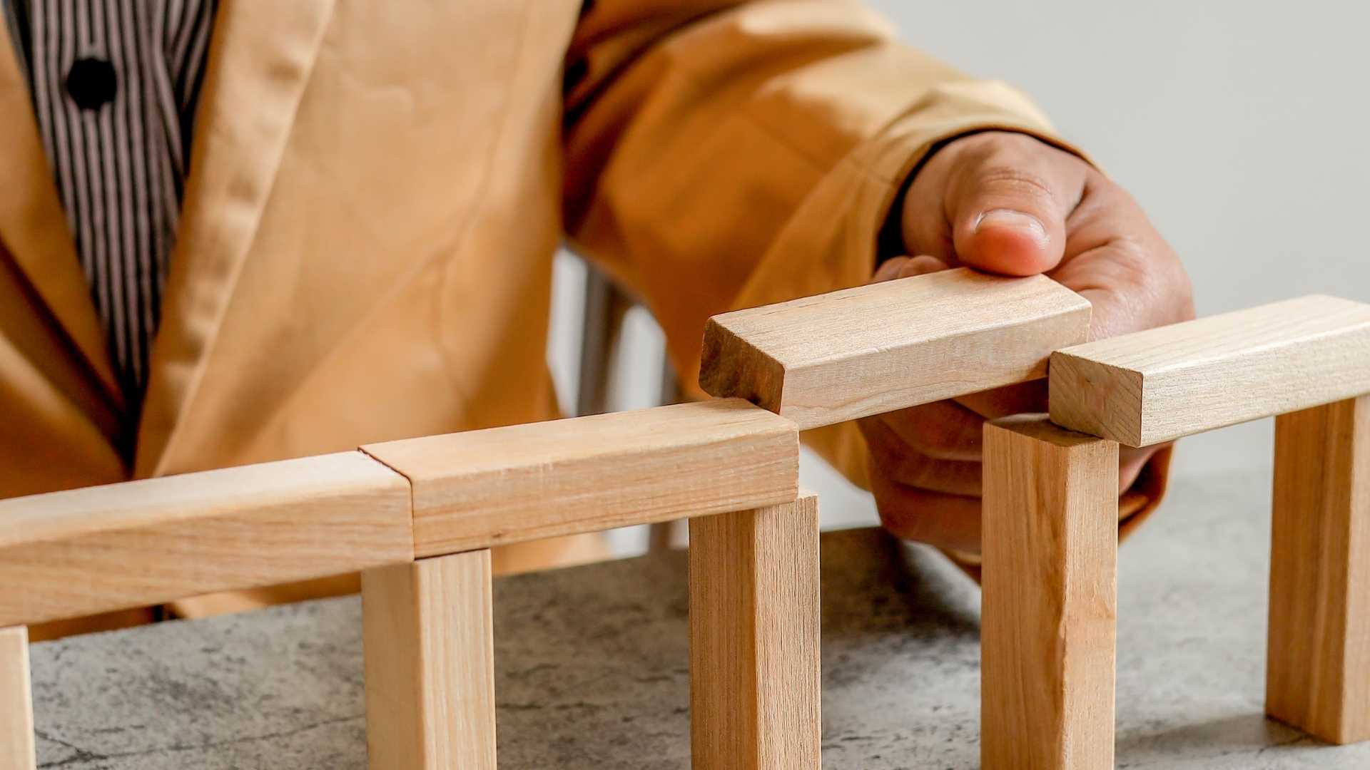 man connect gaps in a wooden structure