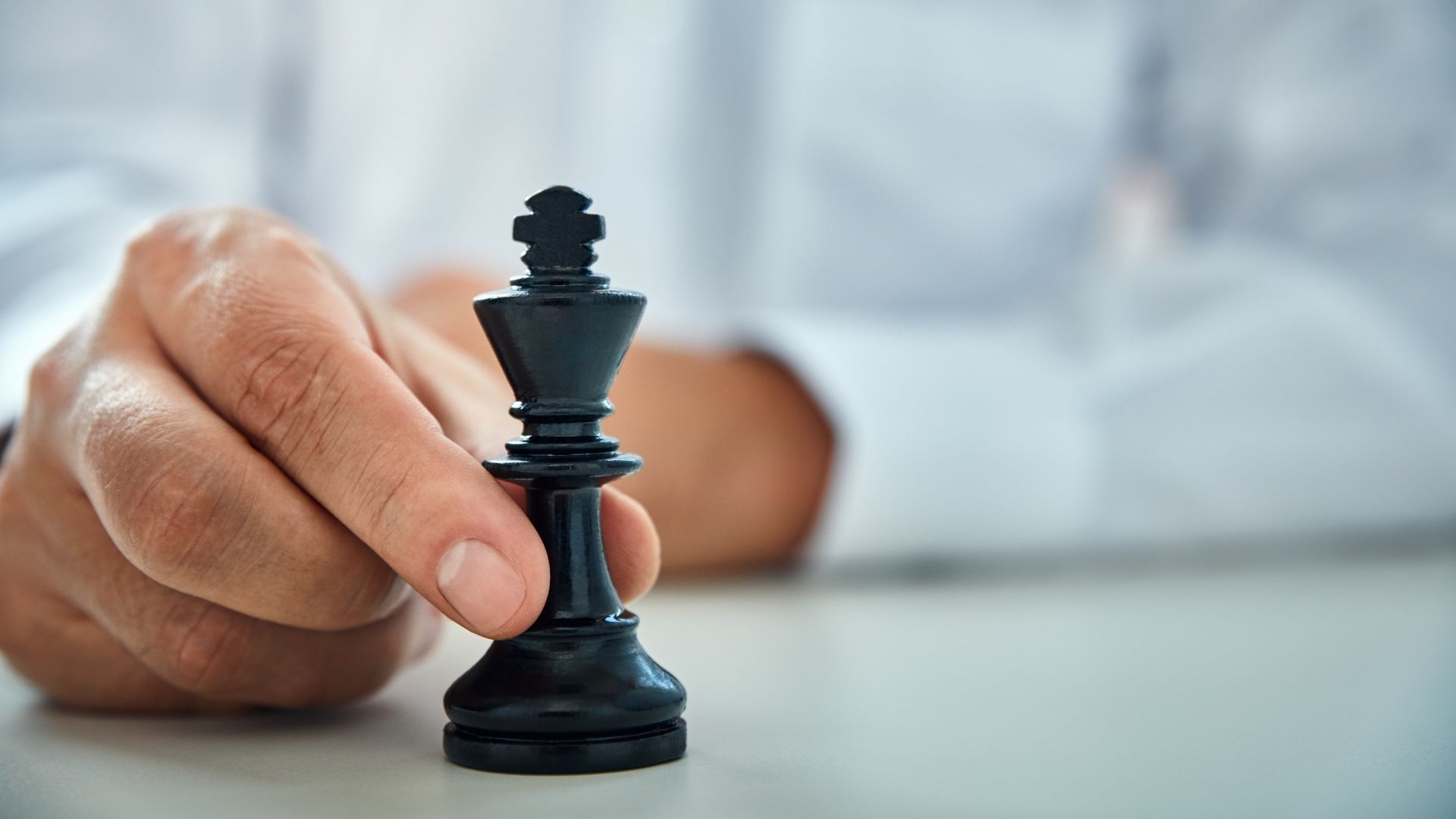 man holding a chess piece