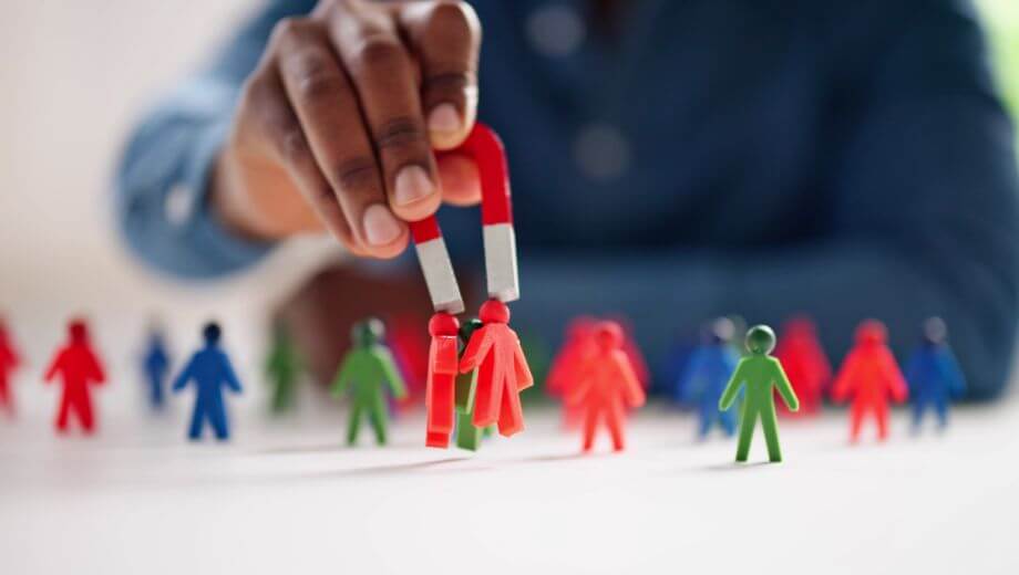 man holding magnet with human figures