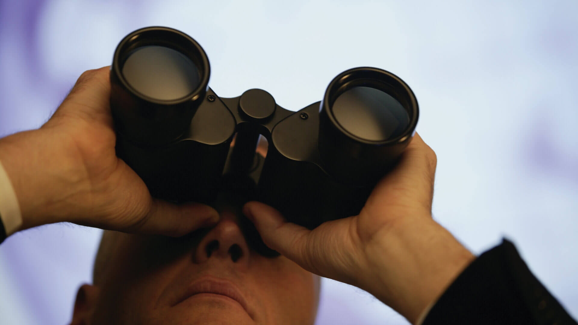 man in suit checking with binocular