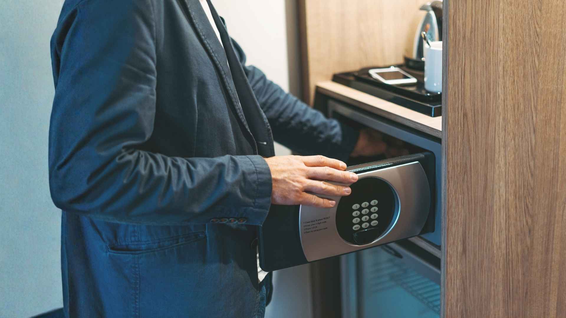 man keeping something in a safe