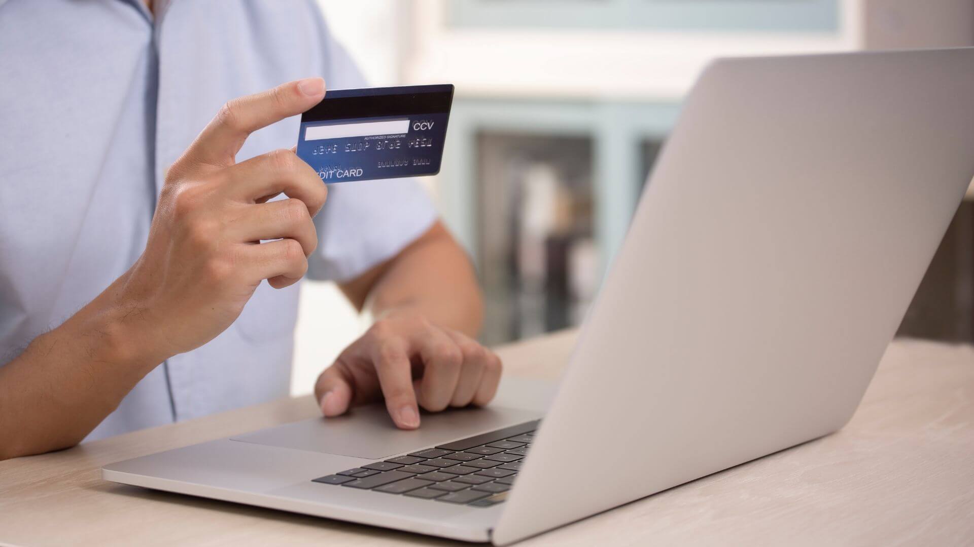 man paying subscriptions using his credit card online