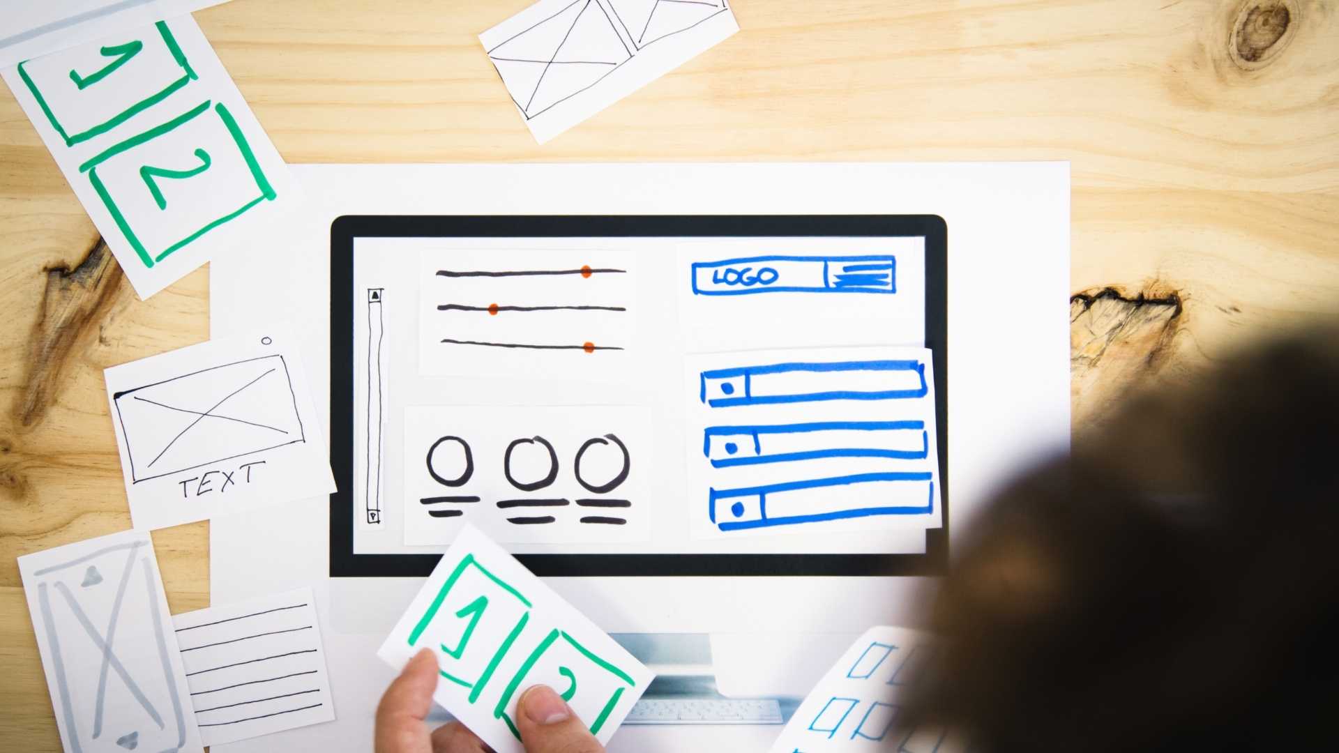 man placing content on website wireframe