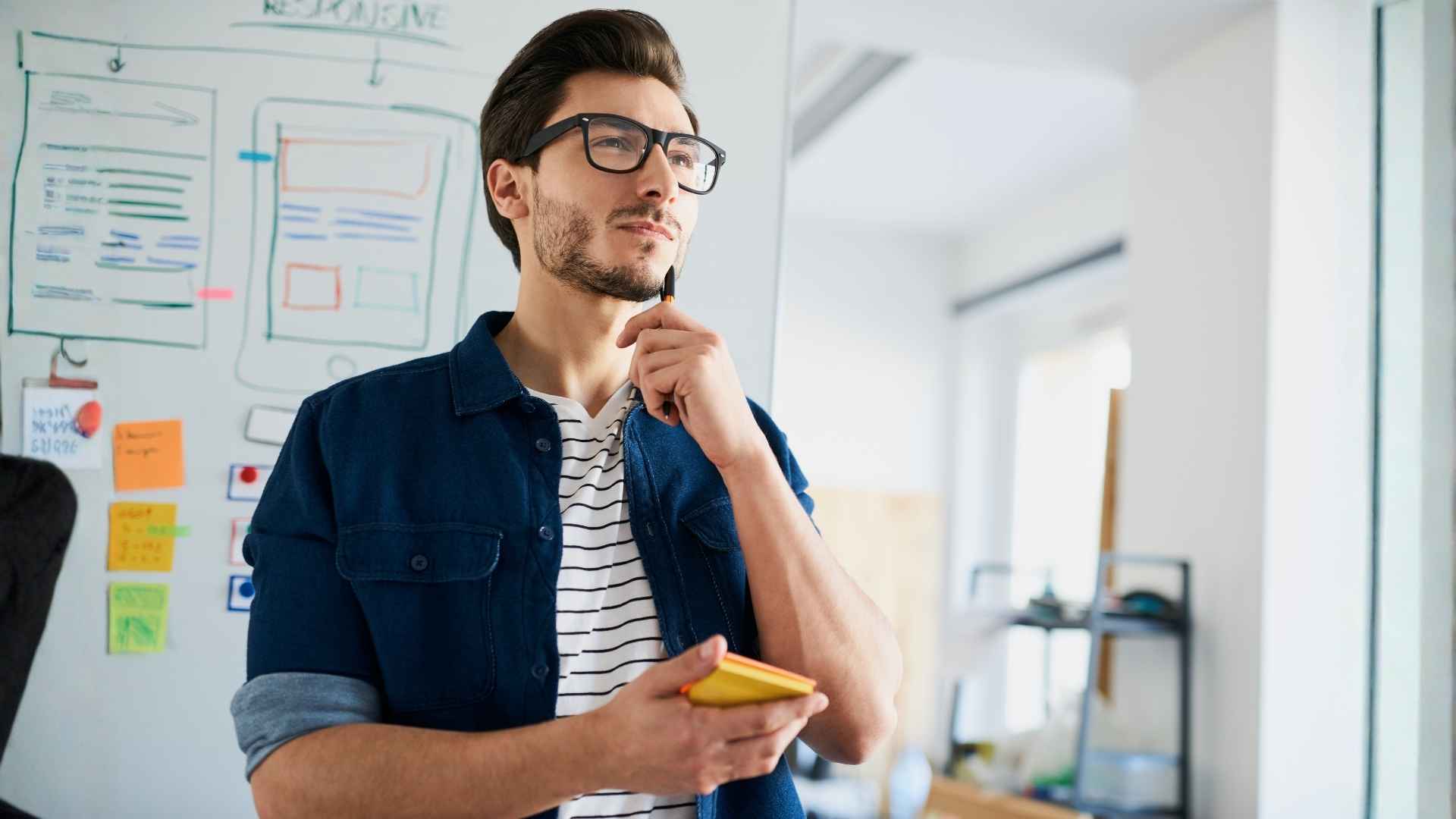 man planning carefully in whiteboard