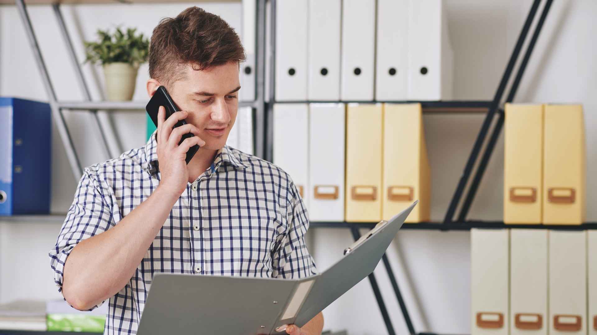 man talking on the phone while reading