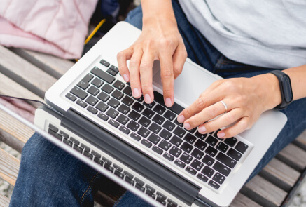 man typing on his laptop