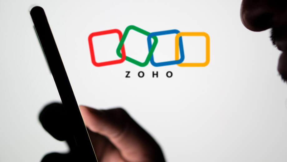 man using mobile phone zoho background