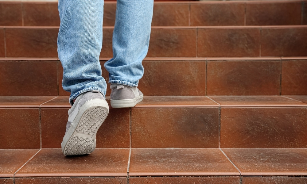 man walking stairs going up