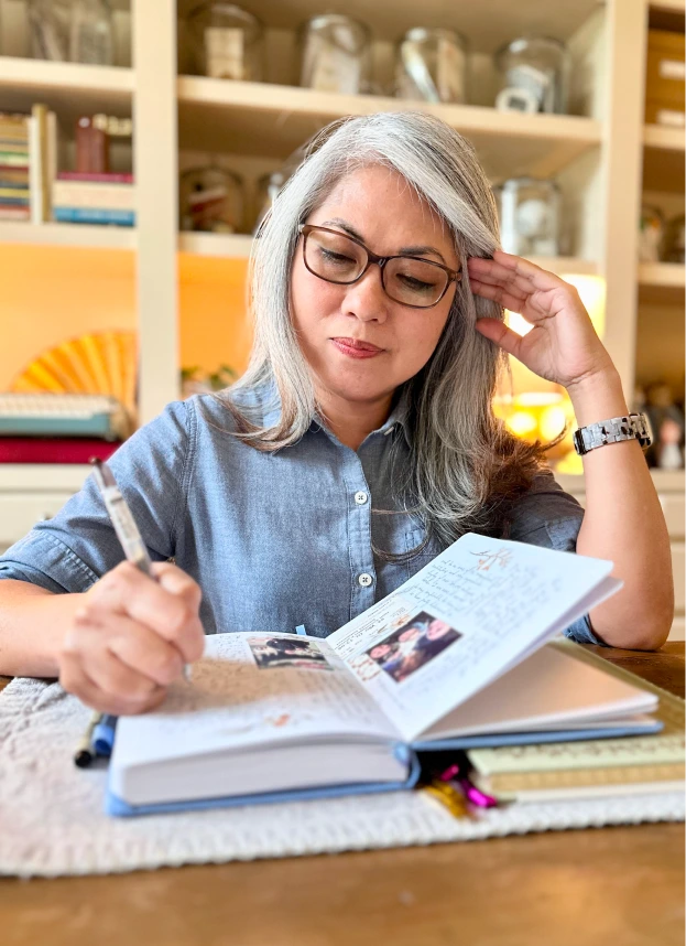 Maria writing on her journal