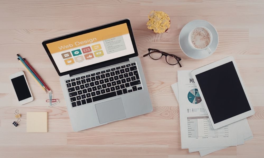 modern workspace setup with laptop and web design in screen