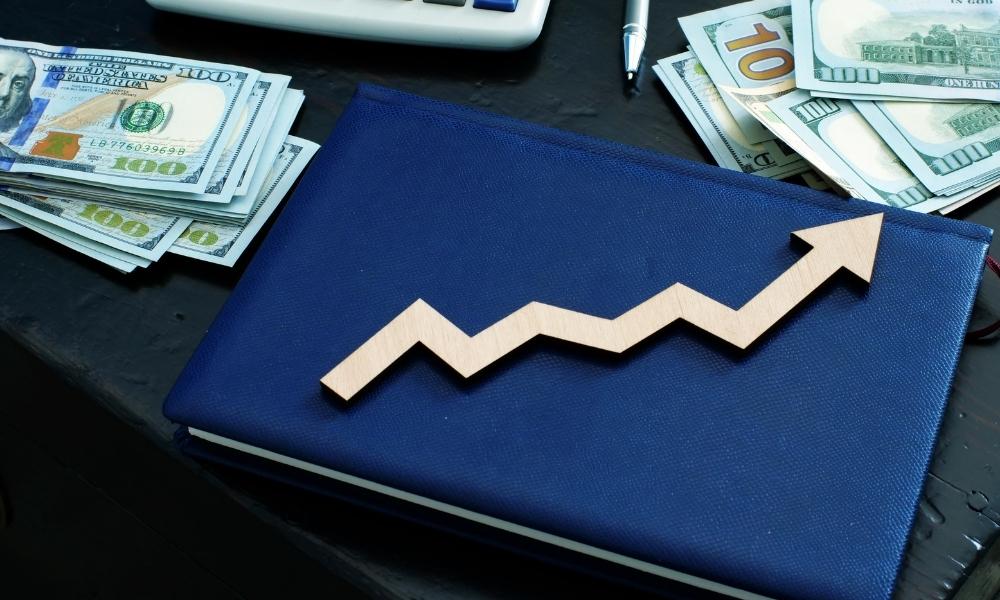 money and arrow on the notebook depictiing wealth management