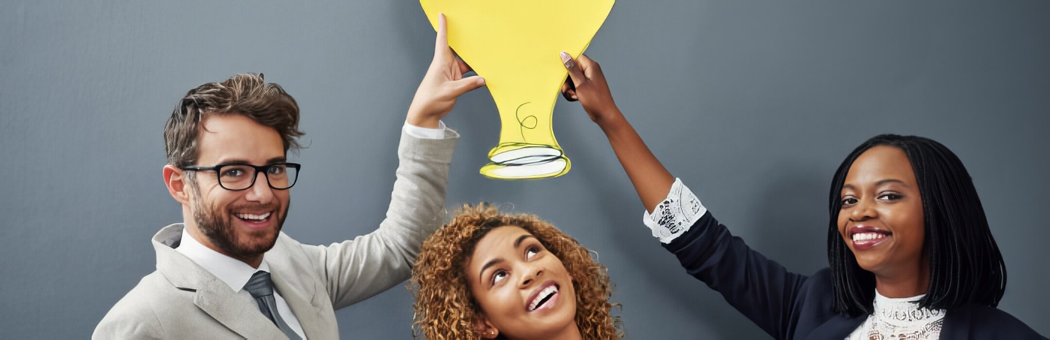 people holding lightbulb over persons head