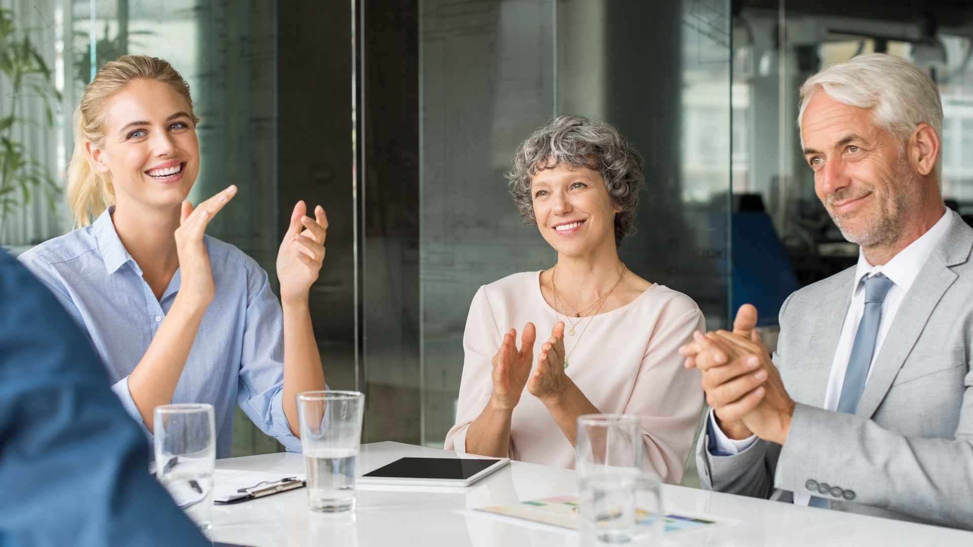 people in the meting clapping hands