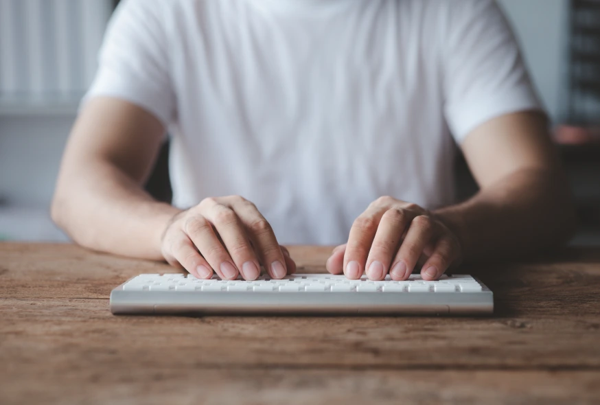 person typing on the wireless keyboard