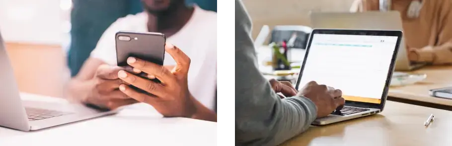 Person using a smartphone and another person working on a laptop