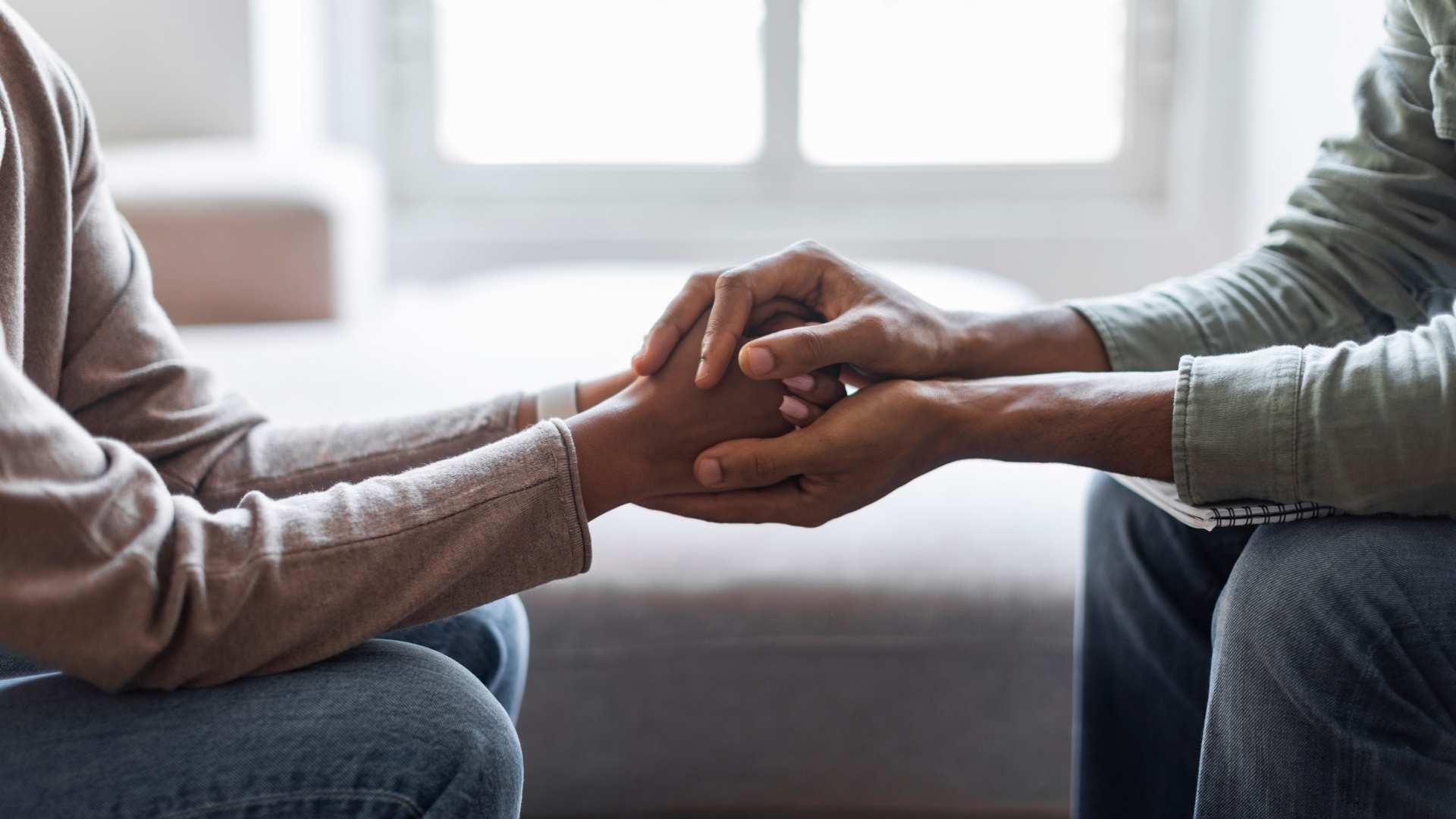 psychologists holding hands of woman patient
