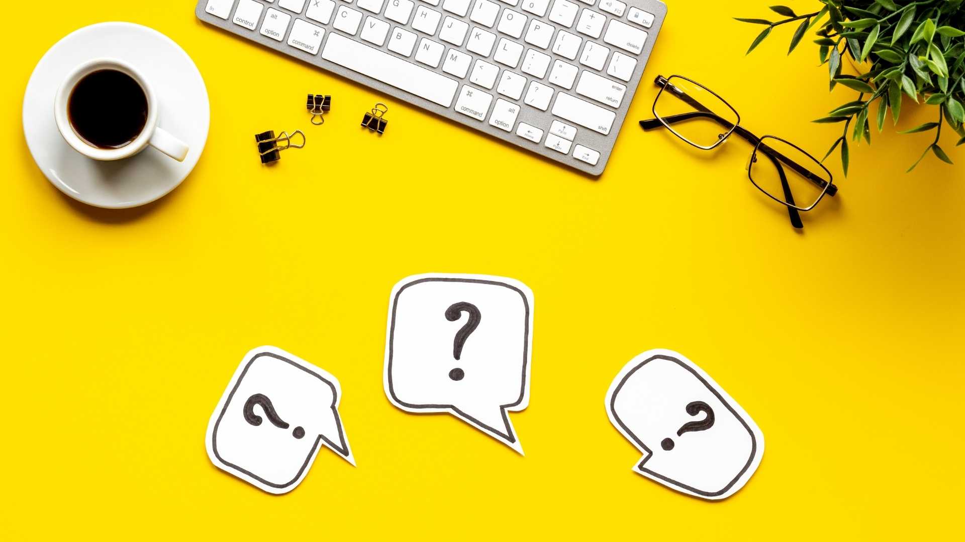 question marks written on a paper above the desk