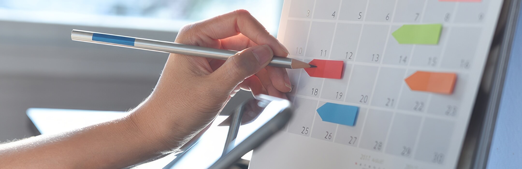 woman marking dates on calendar