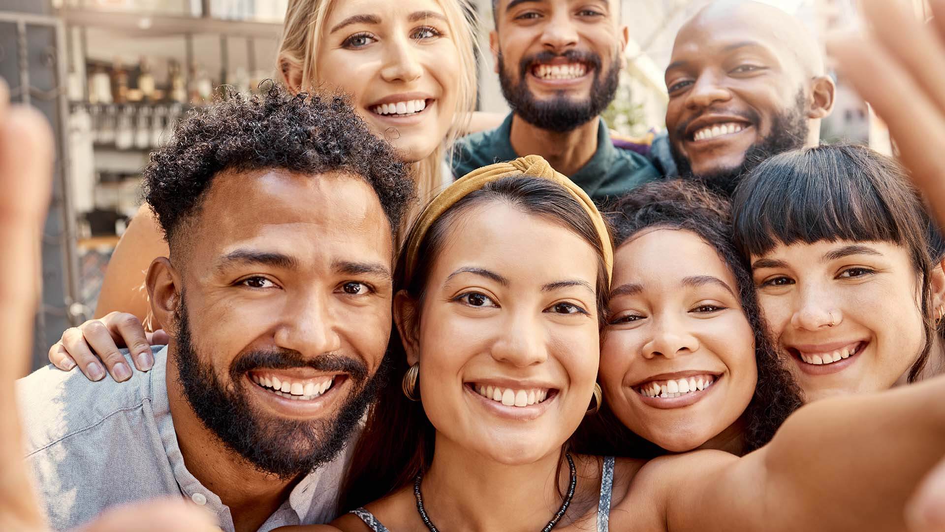 shot-of-a-group-of-young-friends-taking-selfies