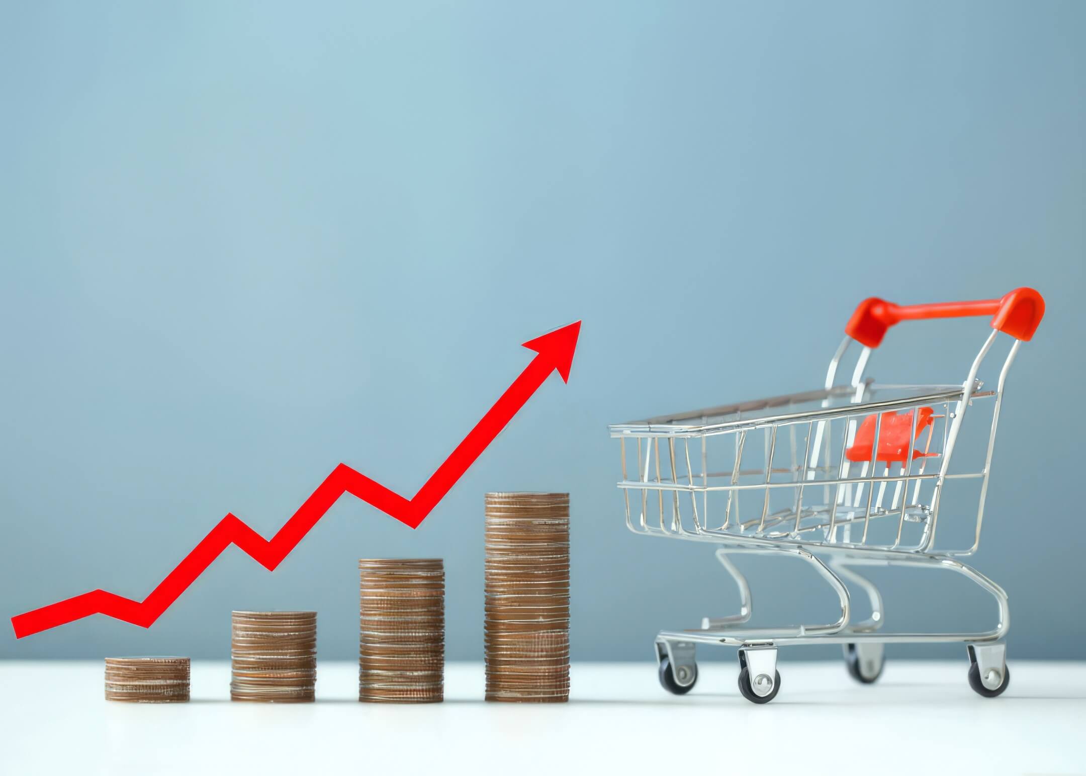 stack of coins with red arrow pointing up and shopping cart