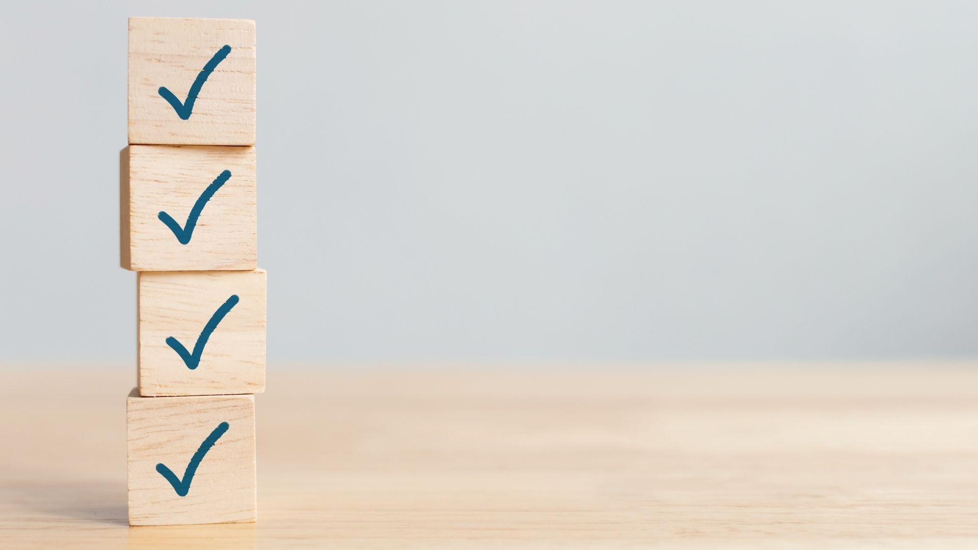 stack of wooden cubes with check mark logos