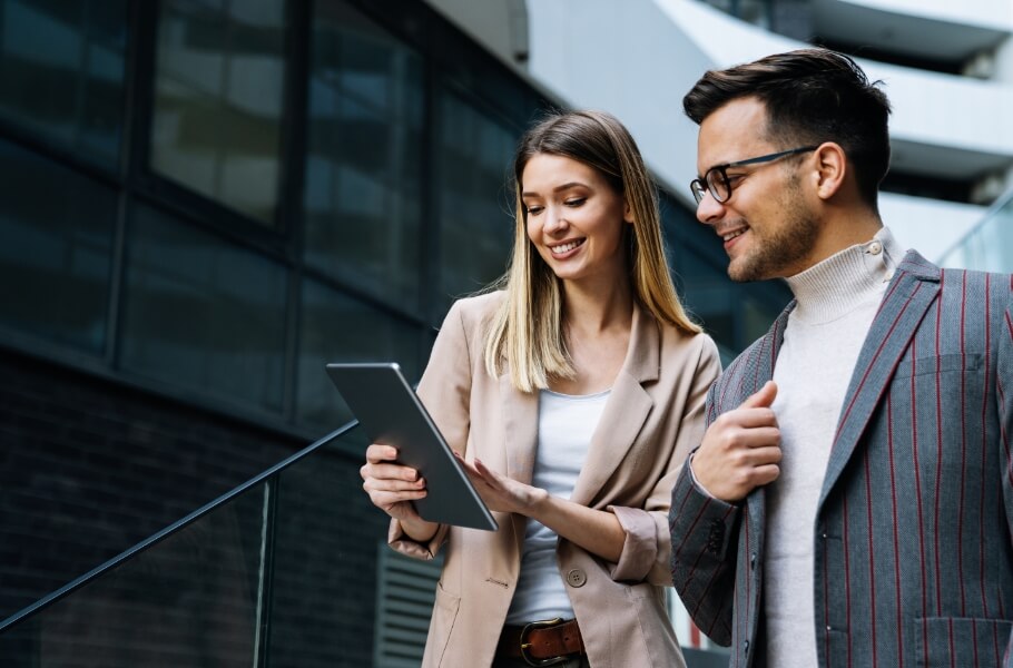 two person looking at tablet