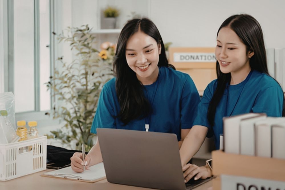 two volunteers looking at a potential website
