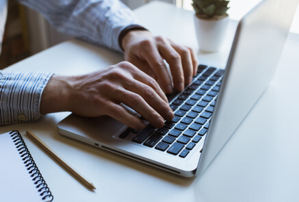 web designer coding on his laptop