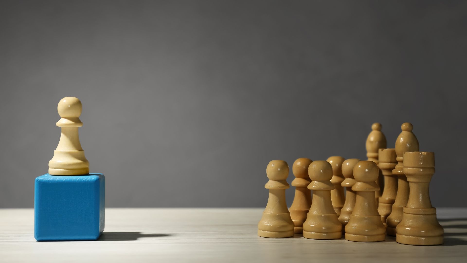 white chess piece standing out from others