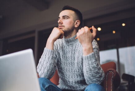 Wistful businessman thinking about project