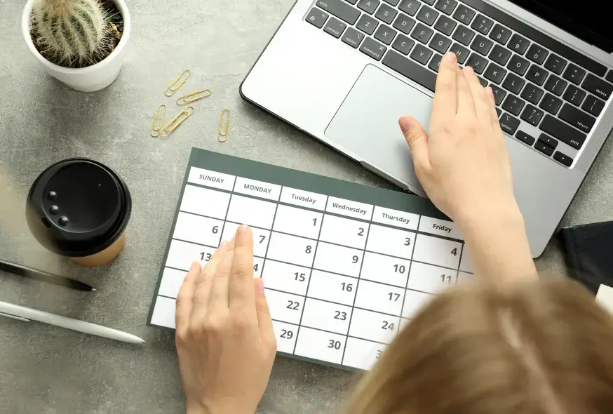 woman checking the schedule from her laptop