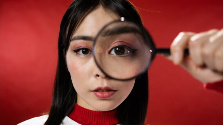 woman checking with a magnifying glass