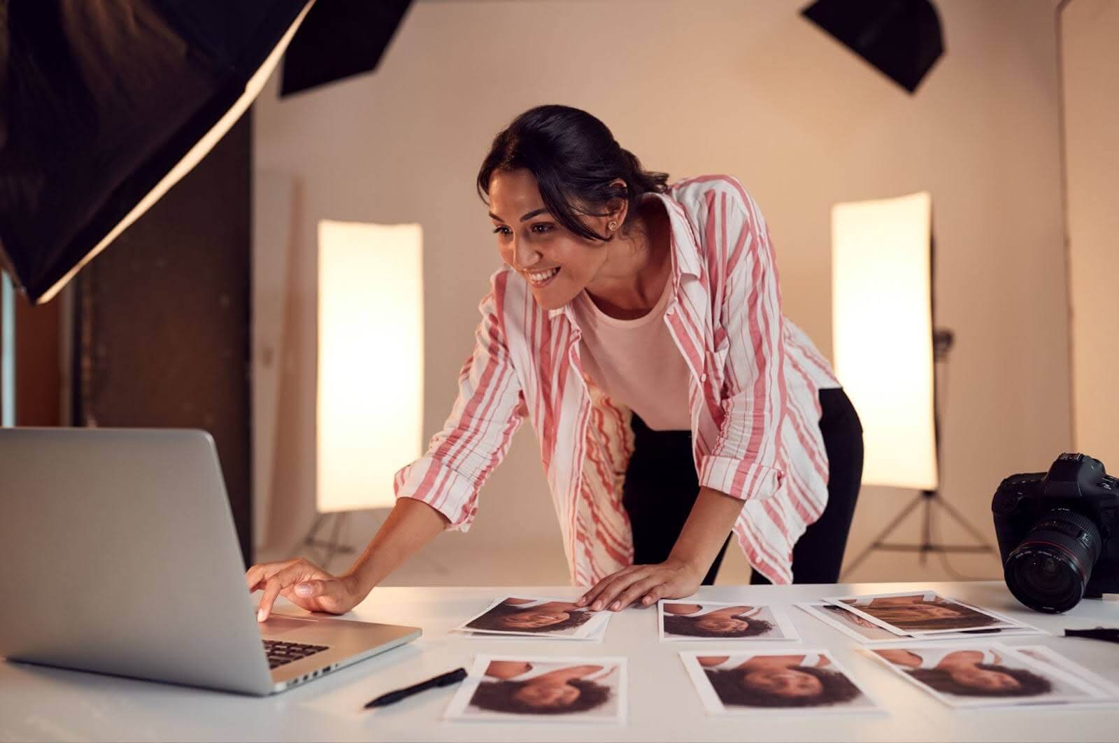 woman checking her laptop after doing photo shoots