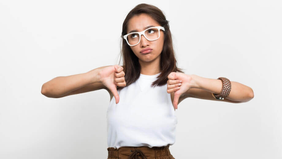 woman in glasses disappointed