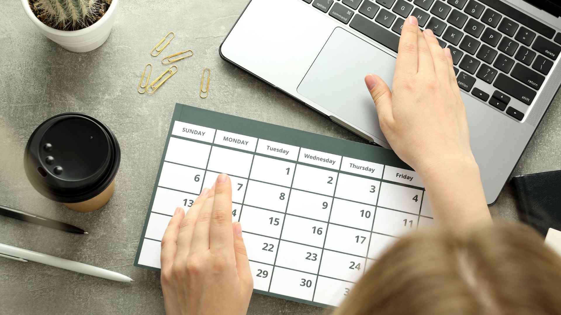 woman marking her calendar and set it on the laptop