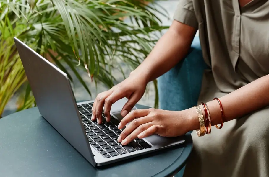 woman typing on her laptop