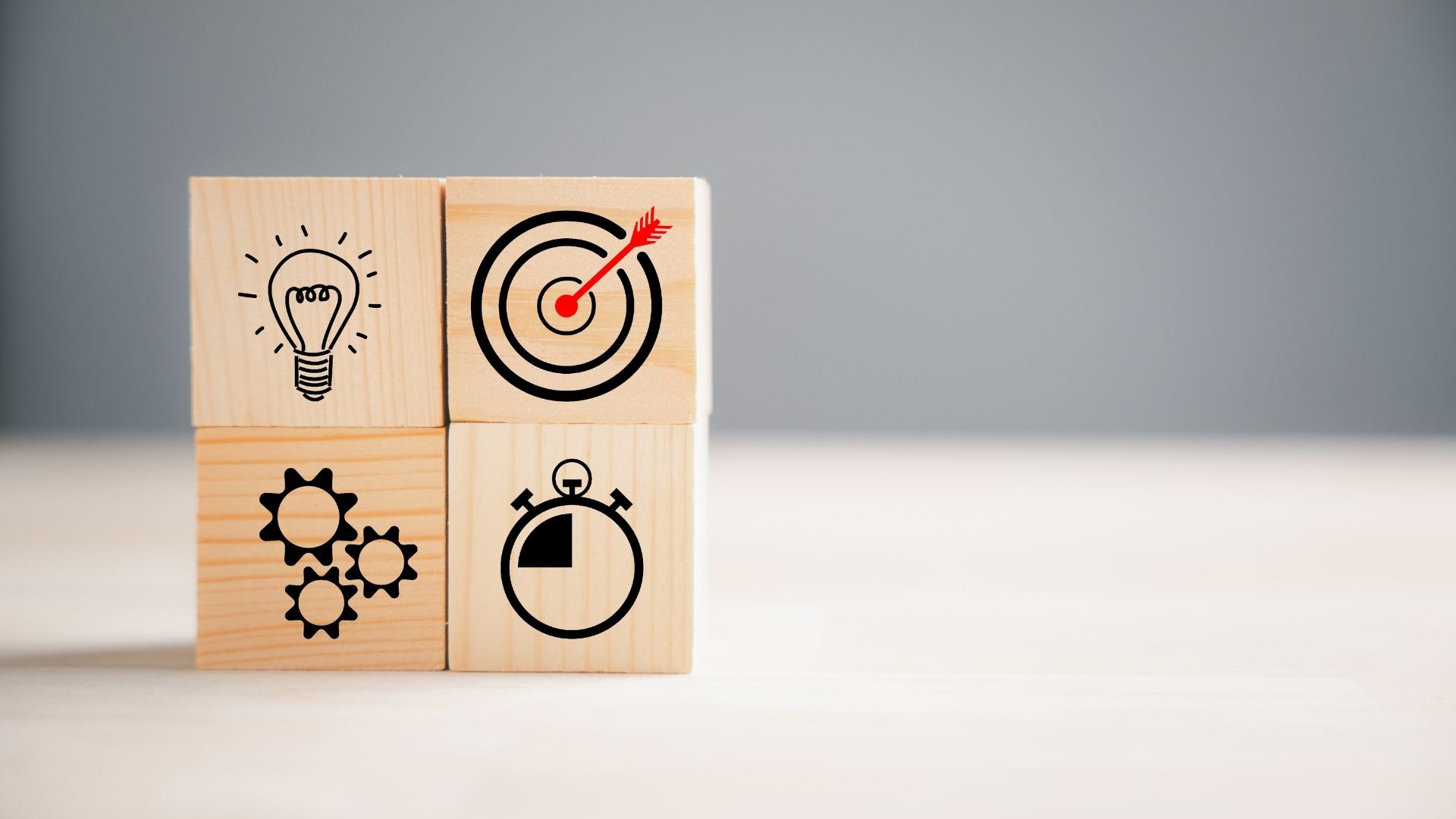 wooden block with icons of action plan
